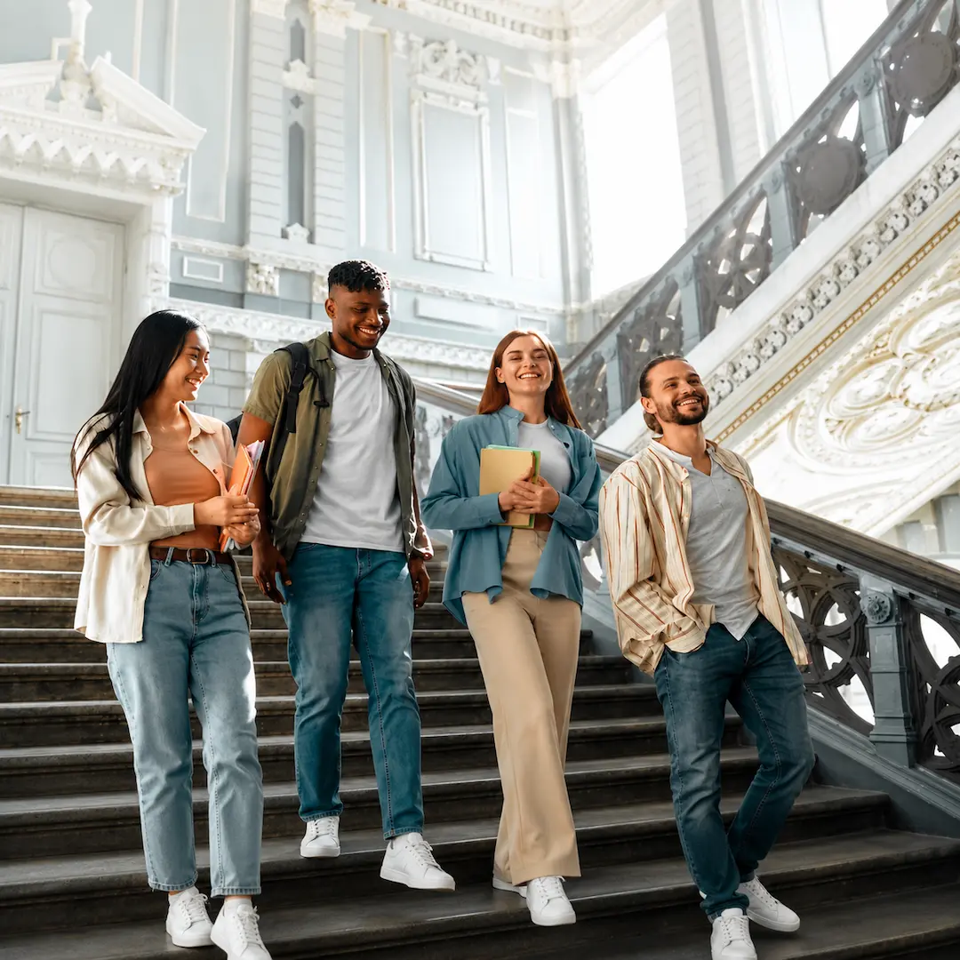 A group of study abroad students walk down a staircase