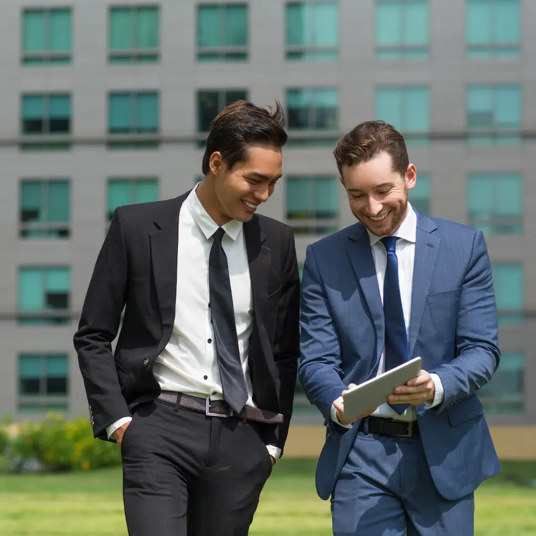 Two business professionals discussing sustainability and ESG initiatives outside a modern office building