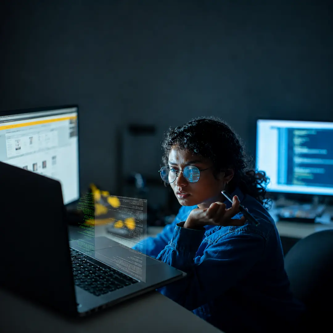 A data scientist looks at data on a computer