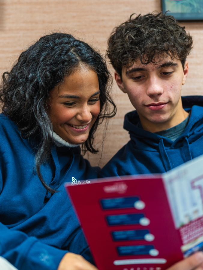 A focused and engaged student in their studies at Schiller International University